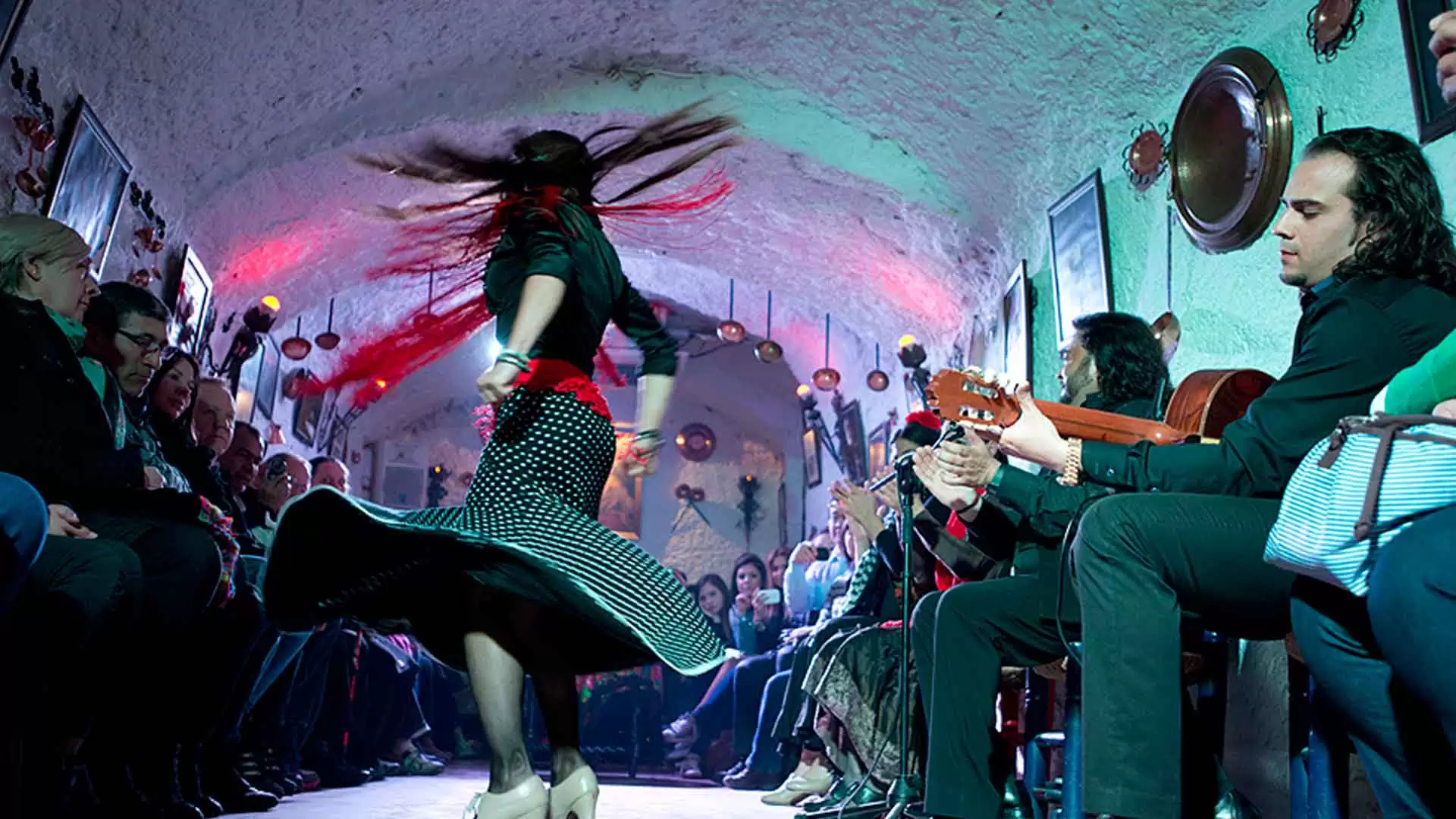 Granada flamenco experience in the Sacromonte caves with dancers, singers, and guitarists performing the traditional Zambra gitana.
